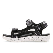 Black and white sandal with speckled sole on a white background