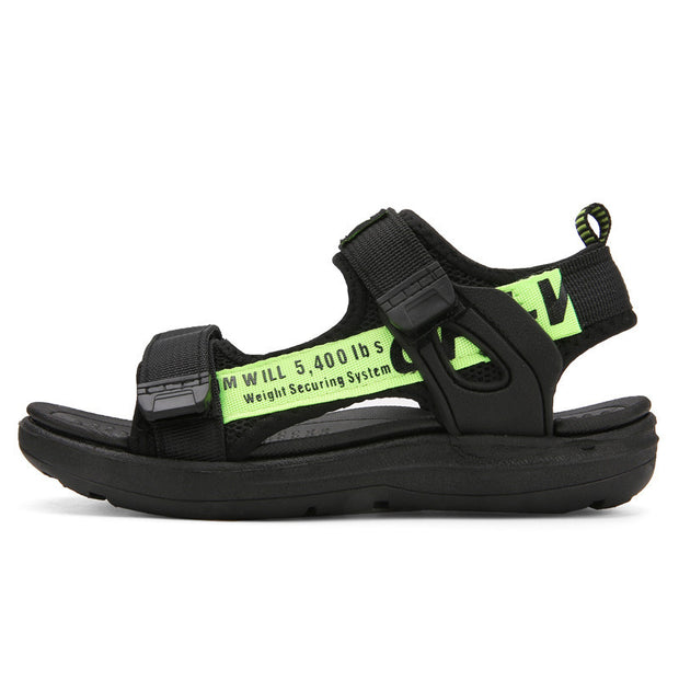 Black sandal with a bright green strap on a white background