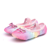 Pair of colorful ballet shoes with pink bows on a white background